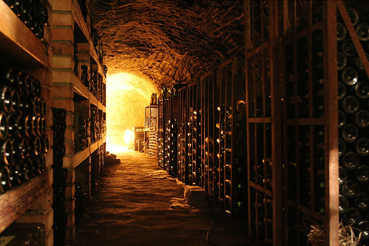Row of aged oak wine barrels in an authentic wine cellar